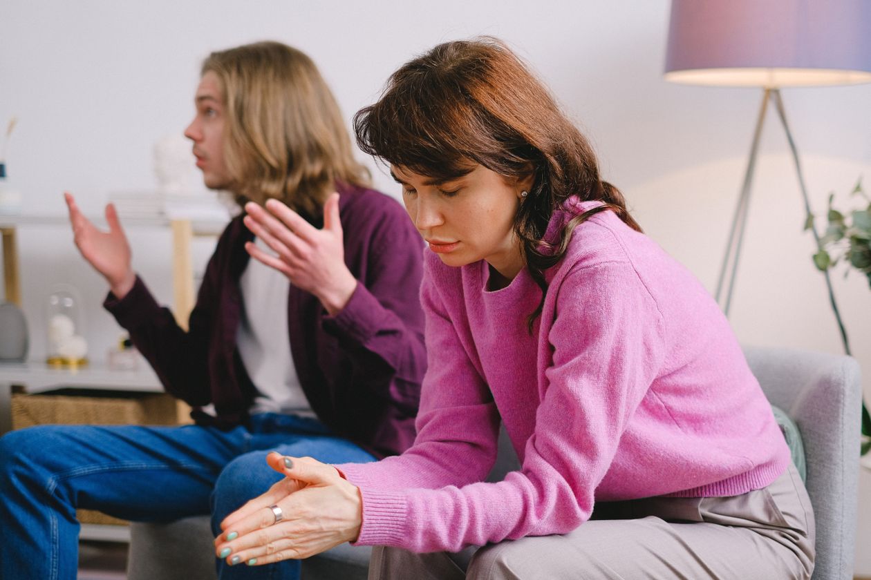 A couple in a serious conversation, one partner looking upset