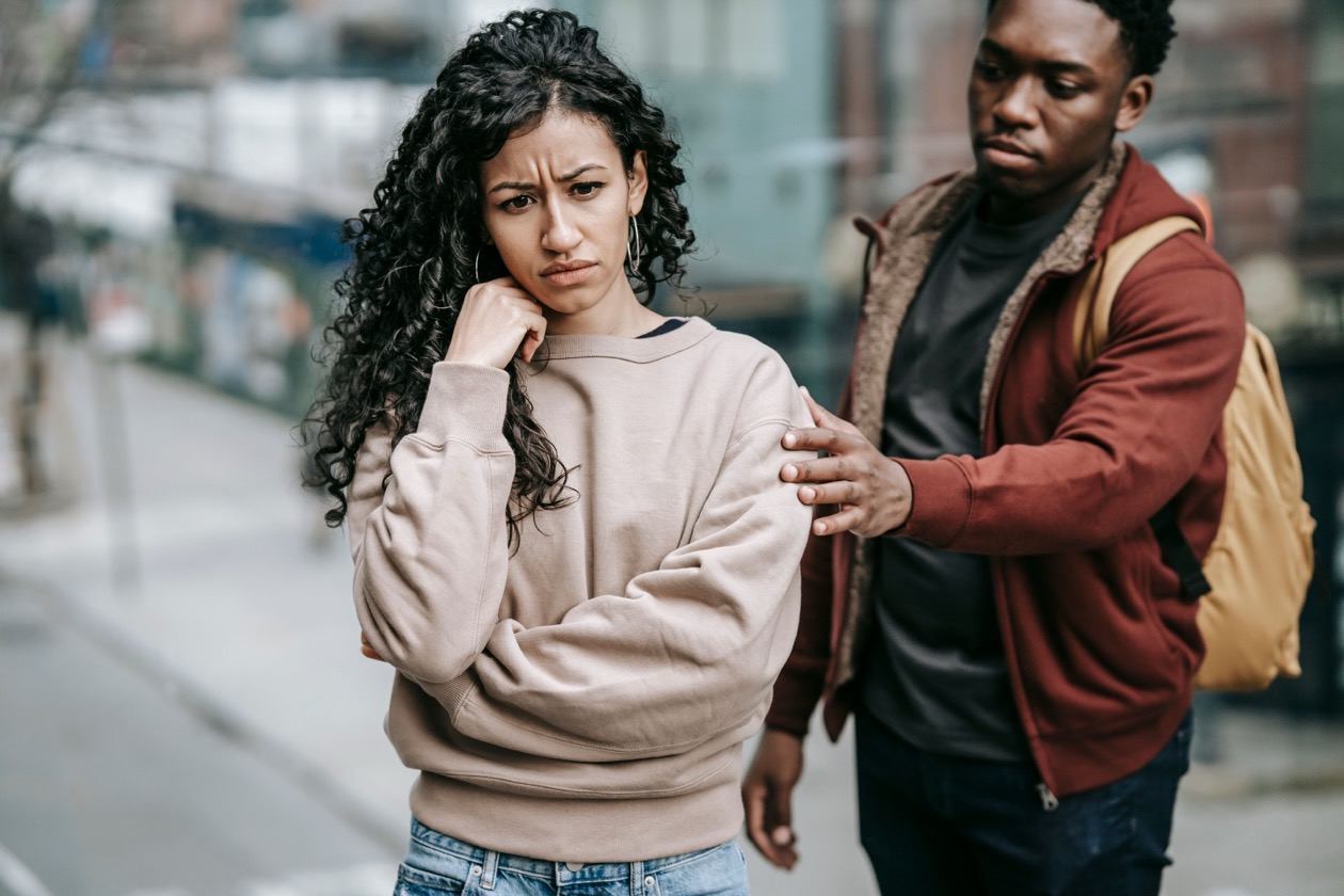 A man comforting his upset partner during a difficult conversation