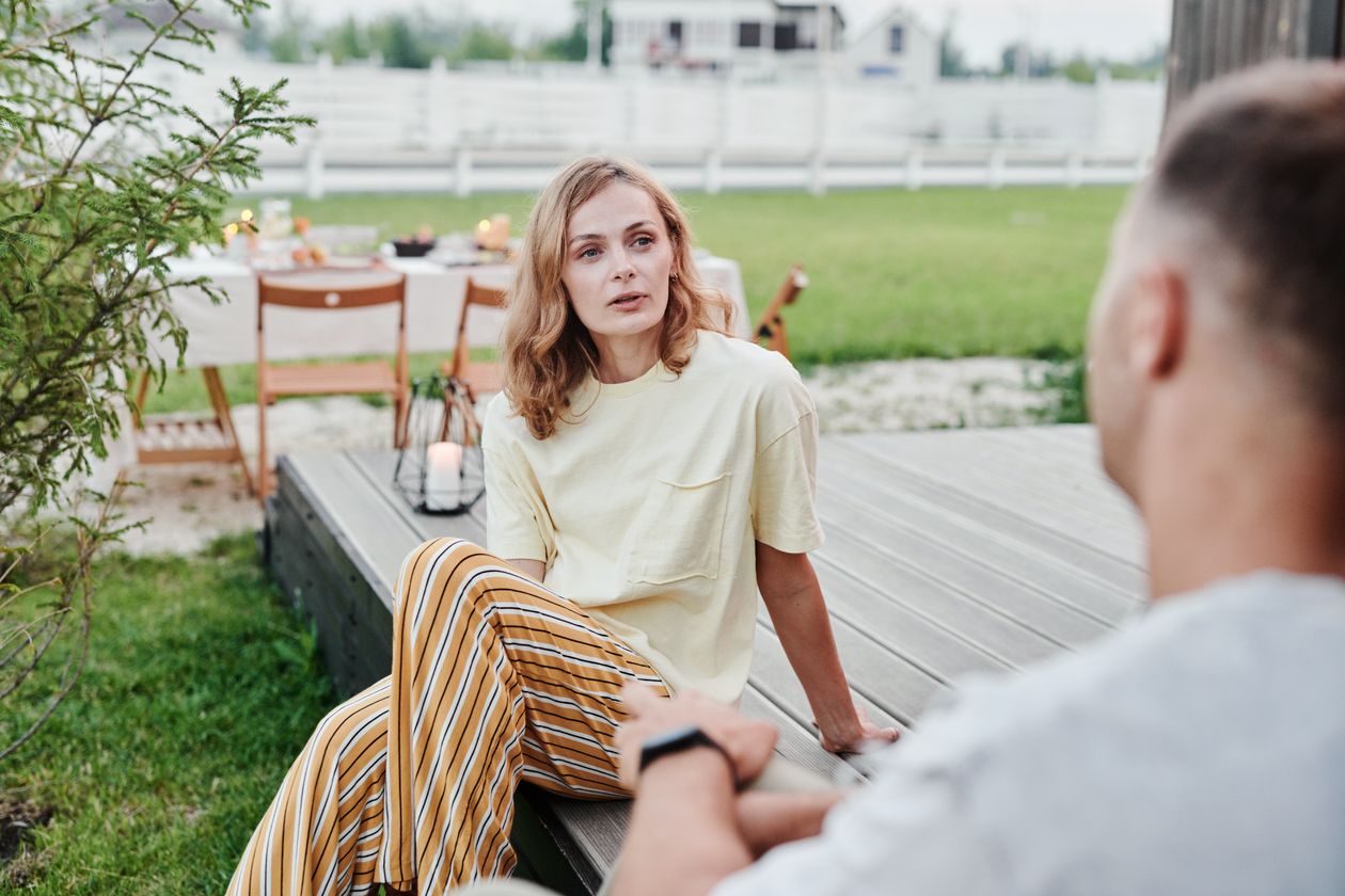 A couple having a thoughtful conversation outdoors