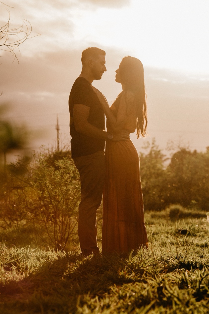 A couple embracing warmly outdoors at sunset