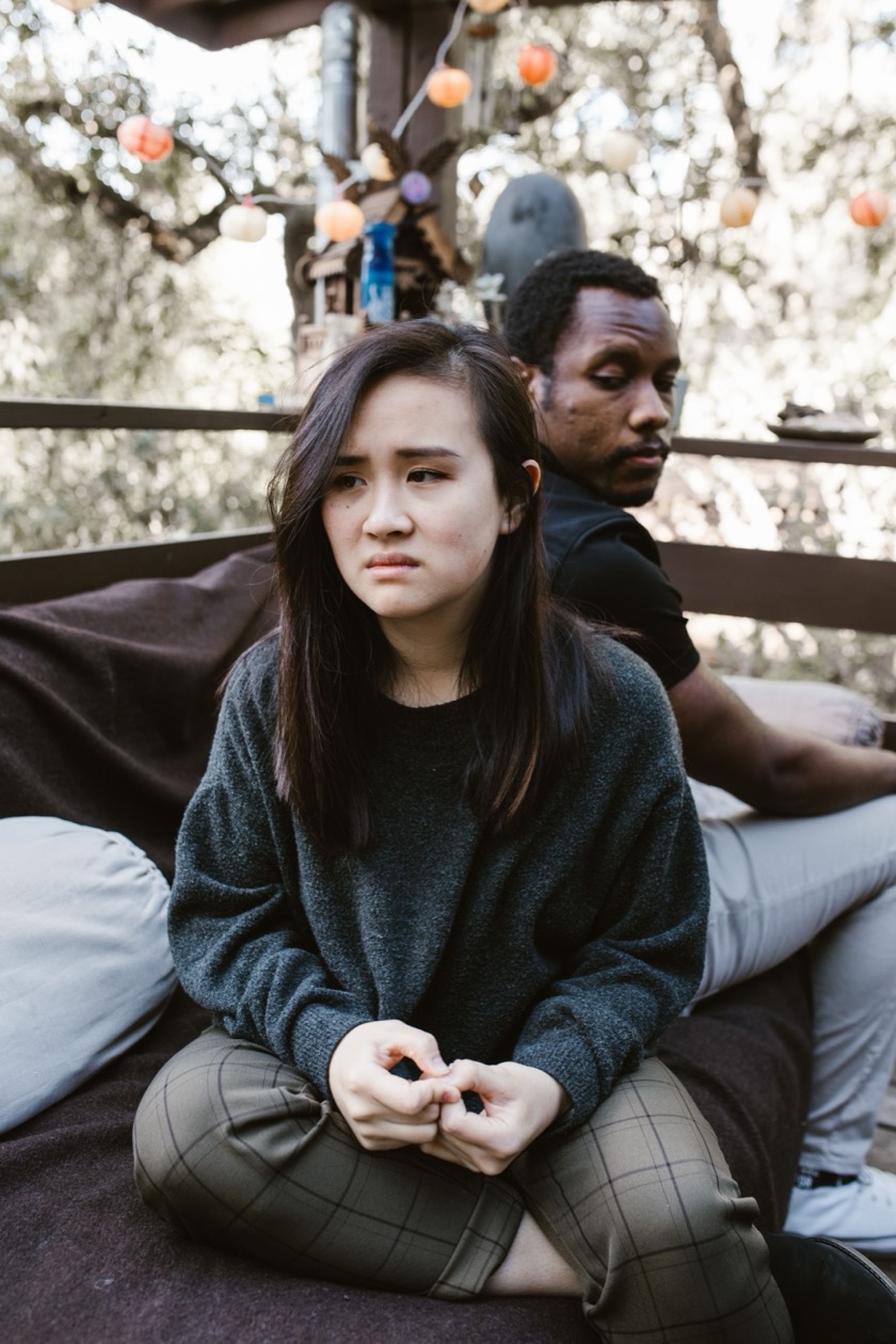 A couple sitting quietly together, taking a moment apart